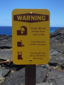 Warning sign overlooking Hōlei Sea Arch, Hawaii. Photo: Isaac Land