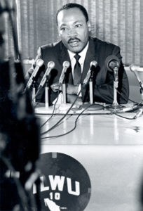 Dr. King speaking into microphones.